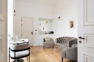 a living room with a couch and a table and chairs at Oca Grande Hotel Do Pezo in Melgaço