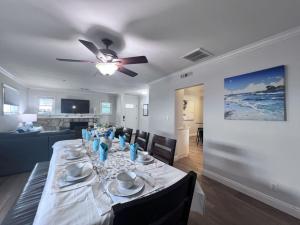 a living room with a dining table with a ceiling fan at Anaheim California, Beautiful Pool Home, Short Walk to Disney in Anaheim
