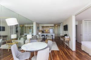 a living room with a couch and a table and chairs at Ilikai Marina 382 in Honolulu