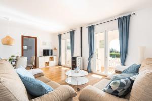 a living room with a couch and a table at Estrella Del Mar with Private Pool in Binibeca