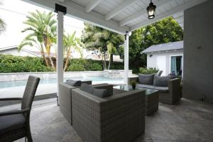 a patio with furniture and a swimming pool at 4 bedroom, 3 bathrooms Pool Home in Orange
