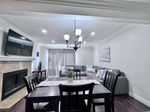 a dining room and living room with a table and a couch at Luxurious 2 Bedroom Condo Shortest Walk To Disney in Anaheim