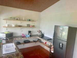 a kitchen with a counter and a refrigerator in it at Casa Isabella in Ángeles