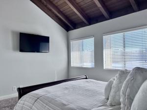 a bedroom with a bed and a flat screen tv at Luxurious 2 Bedroom Condo Shortest Walk To Disney in Anaheim +9 photos