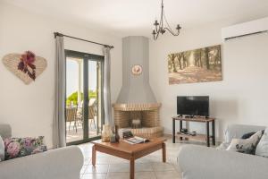 a living room with a couch and a table at Villa Dora in Kefallonia
