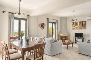 a living room with a table and a couch at Villa Dora in Kefallonia