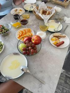 a table with many plates of food on it at Khan Dobo in Bokonbayevo