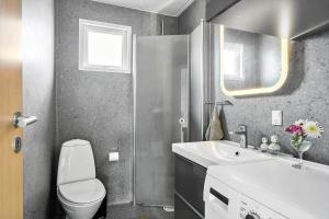 a bathroom with a white toilet and a sink at SJ236-Haderslev-Blokhusskoven-53 in Haderslev +16 photos