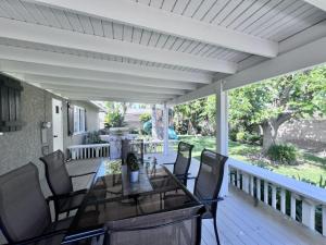 a patio with a table and chairs on a deck at Charming Anaheim Home 1/2 Mile Walk to Disney in Anaheim