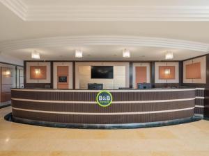 a bar in a hotel lobby with a bac logo at B&B HOTEL Napoli San Mauro in Casalnuovo di Napoli