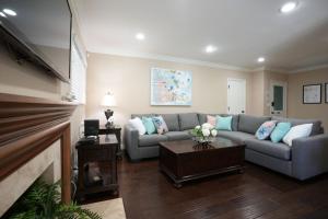 a living room with a couch and a fireplace at Charming Anaheim Home 1/2 Mile Walk to Disney in Anaheim