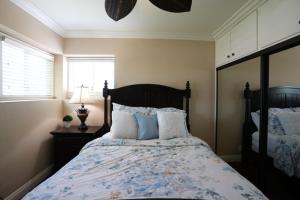 a bedroom with a large bed with pillows at Charming Anaheim Home 1/2 Mile Walk to Disney in Anaheim