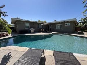 a swimming pool in front of a house at Gorgeous Pool Home 1/2 Mile Walk to Disney in Anaheim