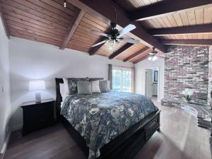 a bedroom with a bed and a ceiling fan at Anaheim California, Beautiful Pool Home, Short Walk to Disney in Anaheim