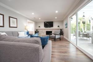 a living room with a couch and a fireplace at 4 bedroom, 3 bathrooms Pool Home in Orange