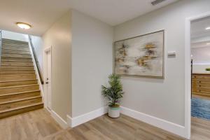 a hallway with stairs and a painting on the wall at 5 Bedroom plus loft room, 3 Bath home in Fullerton