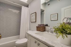 a bathroom with a sink and a toilet and a tub at 5 Bedroom plus loft room, 3 Bath home in Fullerton