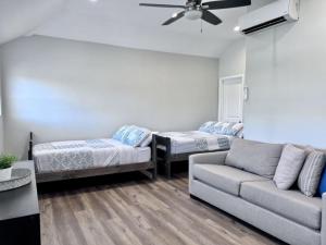 a living room with two beds and a couch at 5 Bedroom plus loft room, 3 Bath home in Fullerton +21 photos