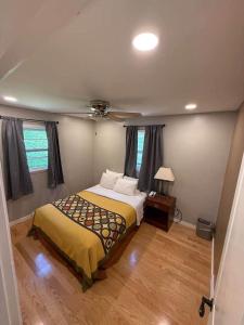 a bedroom with a bed and a ceiling fan at The Vineyard House | Spacious Home Near Wine, Beer & Lake MI in Bridgman