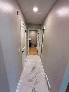 a hallway with a marble floor in a house at The Vineyard House | Spacious Home Near Wine, Beer & Lake MI in Bridgman +4 photos