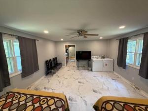 a living room with a large marble floor at The Vineyard House | Spacious Home Near Wine, Beer & Lake MI in Bridgman