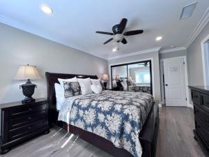 a bedroom with a bed and a ceiling fan at Stunning 8 bedroom 6 bathroom Pool Home in Anaheim +25 photos