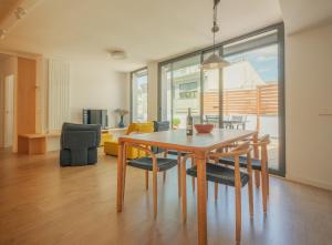 a dining room and living room with a table and chairs at Rutlla 10 in Girona