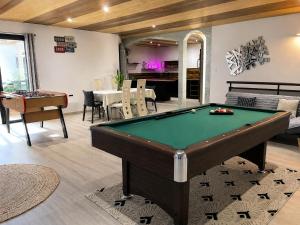 a living room with a pool table in it at L'Escapade Volcanique in Sainte-Rose