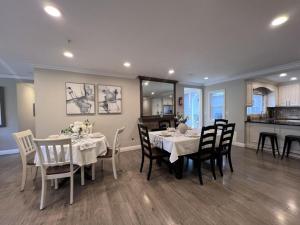 a dining room with a table and chairs and a kitchen at Stunning 8 bedroom 6 bathroom Pool Home in Anaheim