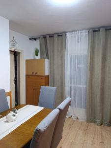 a room with a table and chairs and a window at Rooms IVKA in Plitvička Jezera