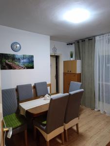 a dining room with a table and chairs at Rooms IVKA in Plitvička Jezera