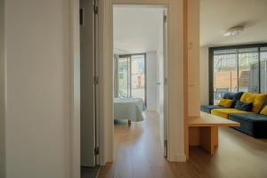 a living room with a couch and a table in a room at Rutlla 10 in Girona