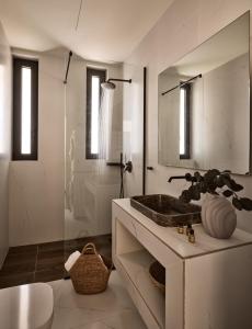 a bathroom with a sink and a mirror at Villa Zeta by Villa Select in Kalamaki +27 photos