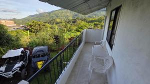 a balcony of a house with two cars parked on it at CASA HOTEL COCORNa in Cocorná