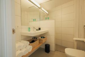 a bathroom with a sink and a toilet and a mirror at Rutlla 10 in Girona +28 photos