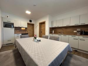 a kitchen with a table with a white table cloth at Panoramablick Zirbitzkogel in Perchau am Sattel