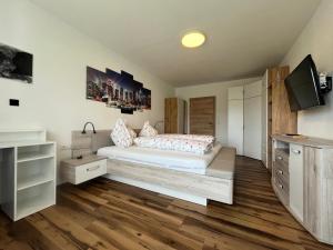 a bedroom with a bed and a tv in it at Panoramablick Zirbitzkogel in Perchau am Sattel