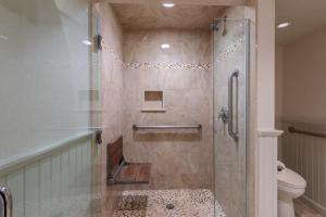 a shower with a glass door in a bathroom at The Meadowmere Resort in Ogunquit +89 photos