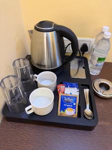 a tray with a coffee pot and ingredients on a counter at De Alcazar Calangute in Calangute