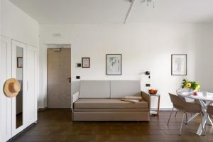 a living room with a couch and a table at Villa Collina in Giardini Naxos