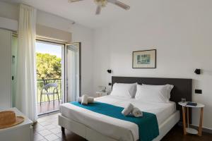 a bedroom with a large bed and a balcony at Villa Collina in Giardini Naxos +115 photos