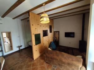 a living room with a couch and a light fixture at Casita La Cometa in Ruidera