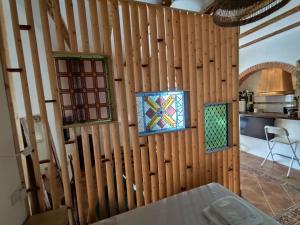 a room with wooden walls with stained glass windows at Casita La Cometa in Ruidera +14 photos