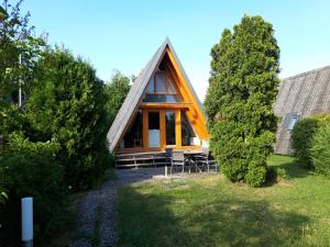 a frame cabin with a thatched roof at Ferienpark Schellbronn - Wolfseeweg 11 und Wolfseeweg 9 in Schellbronn