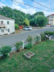 a yard with a fence and a car on a street at Casa Benaxo Ribeira Sacra in Currelos +72 photos