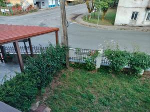 a bench in the grass next to a street at Casa Benaxo Ribeira Sacra in Currelos