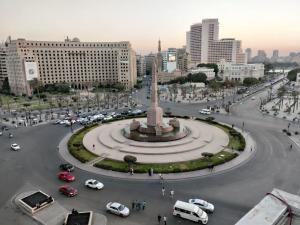 a city with a monument in the middle of a street at Royal Town Hotel in Cairo