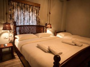 a bedroom with two beds and a window at Rrenjet - The Roots in Ersekë +14 photos