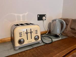 a toaster sitting next to a coffee maker on a counter at Oakdean Cottage Yurt in Blakeney