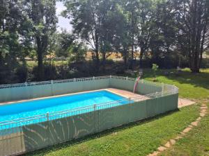 a swimming pool with a fence around it at 24h sur24 in Foissac